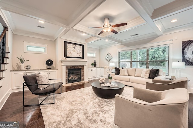 3699 School St, Chamblee, GA 30341 - living room featuring dark wood-type flooring, a stone fireplace, beam ceiling, coffered ceiling, and a ceiling fan