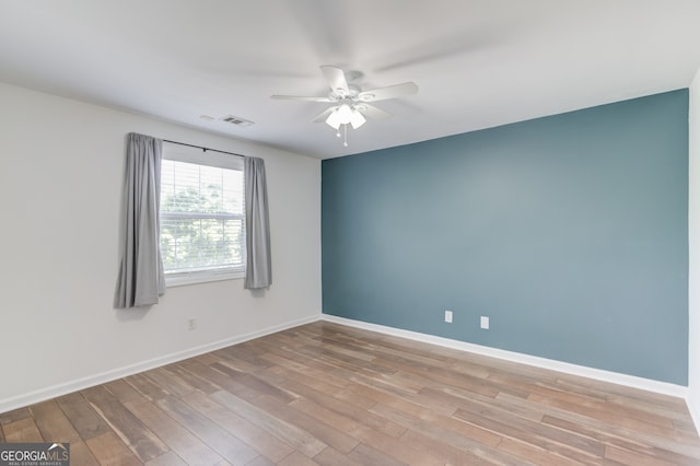 3987 Ivory Gables Pl, Buford, GA 30519 - spare room featuring a ceiling fan, wood finished floors, and baseboards