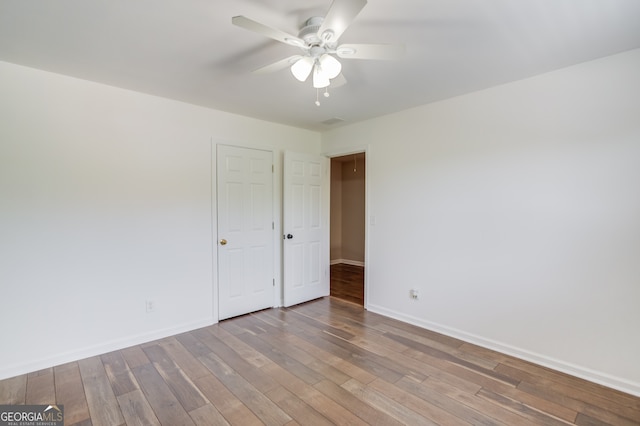 3987 Ivory Gables Pl, Buford, GA 30519 - unfurnished room with a ceiling fan, baseboards, and wood finished floors