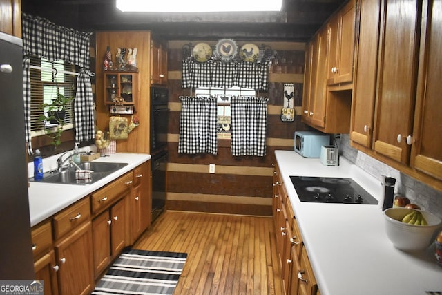 6503 Old Macon Hwy, Rex, GA 30273 - kitchen with black appliances, brown cabinets, light countertops, and a sink