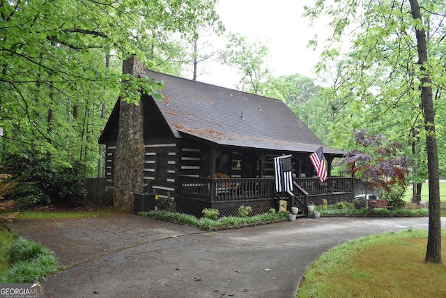 6503 Old Macon Hwy, Rex, GA 30273 - log home featuring log siding, driveway, a chimney, central AC, and a porch