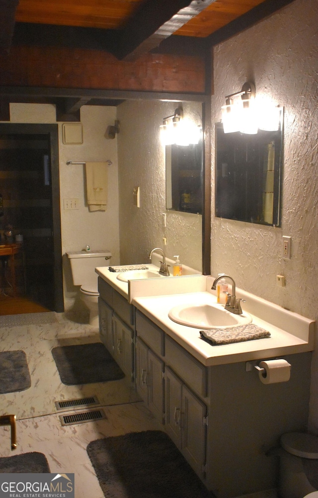 6503 Old Macon Hwy, Rex, GA 30273 - bathroom featuring visible vents, toilet, a textured wall, and vanity