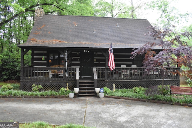 6503 Old Macon Hwy, Rex, GA 30273 - view of front facade featuring roof with shingles, a chimney, and covered porch