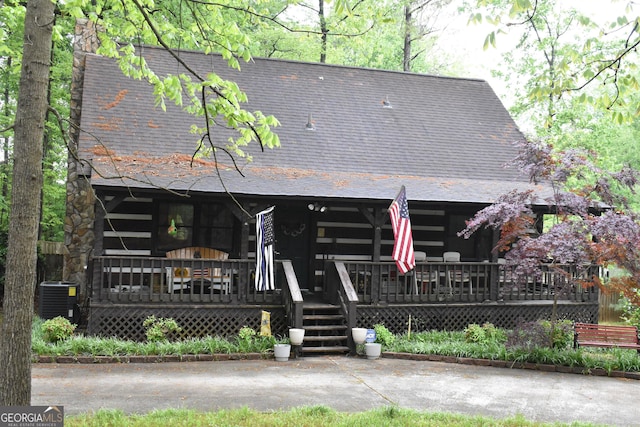 6503 Old Macon Hwy, Rex, GA 30273 - log-style house with cooling unit, a shingled roof, covered porch, and log siding