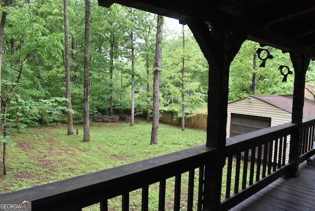 6503 Old Macon Hwy, Rex, GA 30273 - wooden deck with a garage, a wooded view, an outdoor structure, and a yard