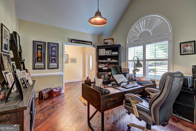home office with wood finished floors and high vaulted ceiling