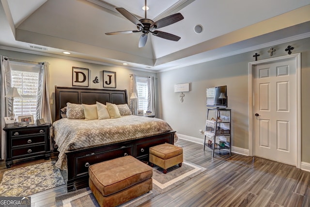 bedroom featuring a raised ceiling, visible vents, baseboards, recessed lighting, and wood finished floors