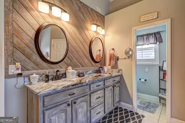 bathroom with tile patterned floors, double vanity, and a sink