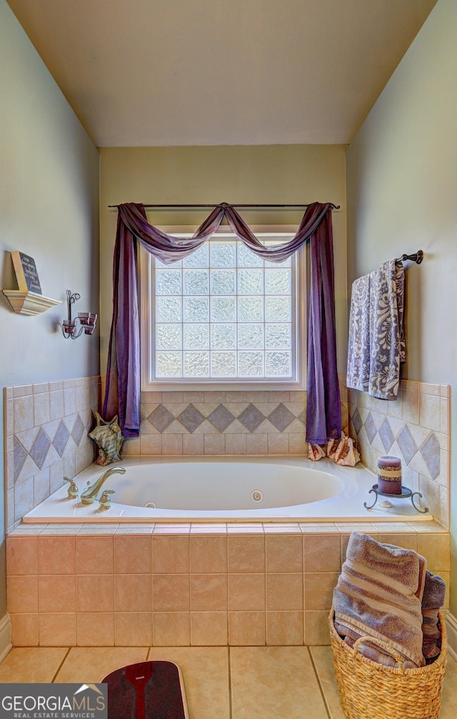 full bathroom featuring a bath and tile patterned flooring
