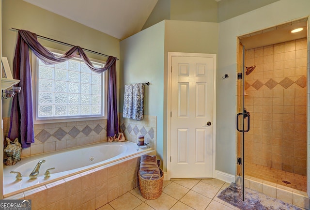 full bath with tile patterned floors, a shower stall, a bath, and vaulted ceiling