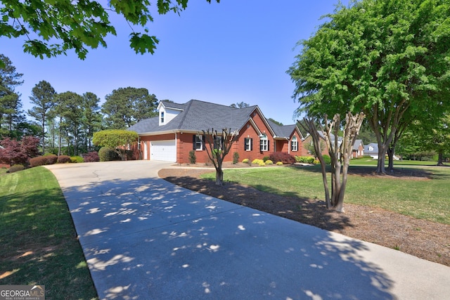 view of front of property with a front lawn, driveway, a garage, and brick siding