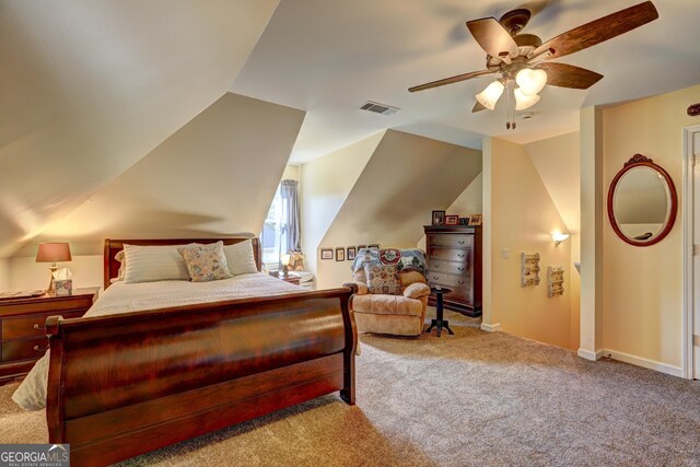 carpeted bedroom with visible vents, ceiling fan, and vaulted ceiling