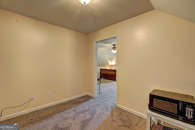 interior space with lofted ceiling, carpet floors, and baseboards