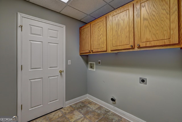 laundry room with hookup for an electric dryer, baseboards, hookup for a washing machine, cabinet space, and tile patterned floors
