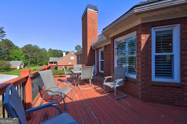 wooden terrace with outdoor dining space