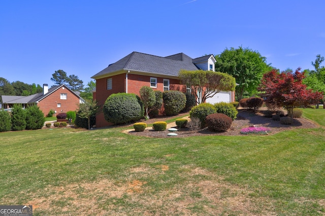 view of home's exterior featuring a lawn, a shingled roof, brick siding, and a garage