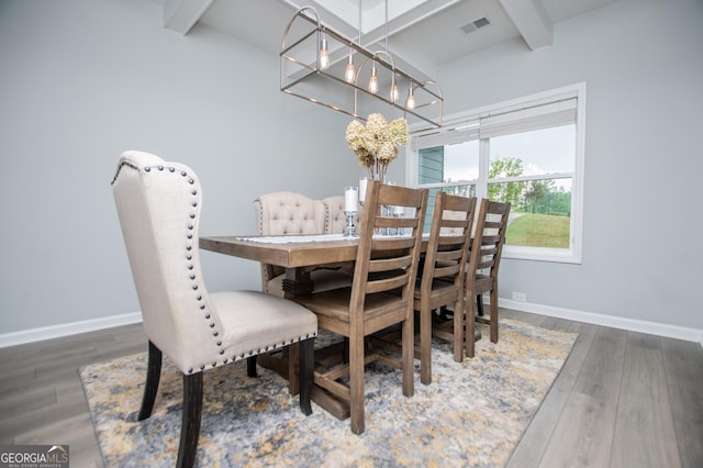 405 Adler Pt, Carrollton, GA 30117 - dining space featuring beamed ceiling, wood finished floors, and a chandelier