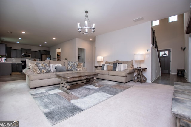 carpeted living area featuring a chandelier, recessed lighting, and healthy amount of natural light