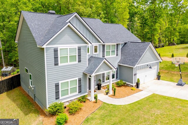 view of front of house featuring board and batten siding, a garage, a shingled roof, and driveway
