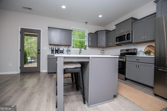 405 Adler Pt, Carrollton, GA 30117 - kitchen featuring appliances with stainless steel finishes, light wood-style floors, decorative backsplash, and recessed lighting