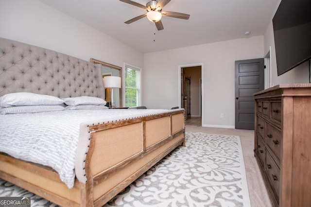 bedroom featuring light colored carpet, ceiling fan, and baseboards