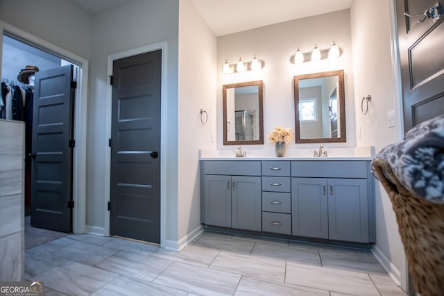 bathroom featuring baseboards and double vanity