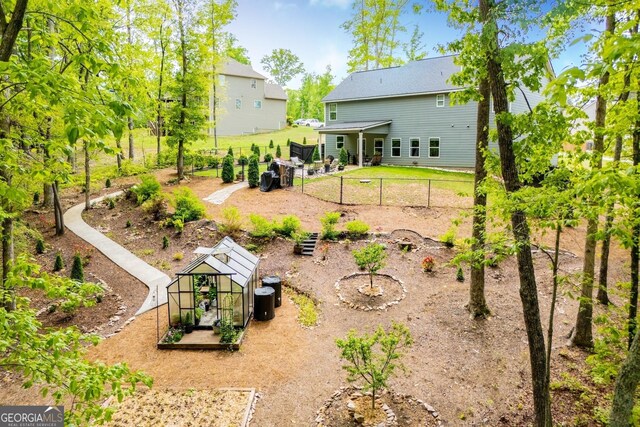 rear view of property featuring fence