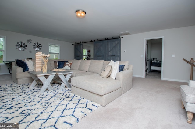carpeted living room with baseboards and healthy amount of natural light