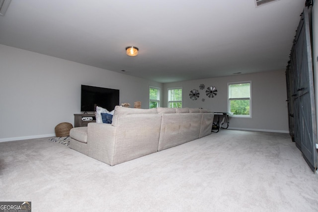 living room featuring baseboards and light colored carpet