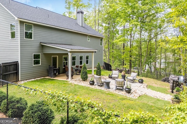 405 Adler Pt, Carrollton, GA 30117 - rear view of house featuring a patio, a chimney, a fenced backyard, and a shingled roof