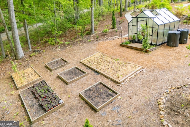 405 Adler Pt, Carrollton, GA 30117 - view of yard featuring a greenhouse, a vegetable garden, and an outdoor structure
