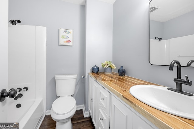 2352 S Hairston Rd, Decatur, GA 30035 - bathroom featuring washtub / shower combination, vanity, toilet, wood finished floors, and visible vents
