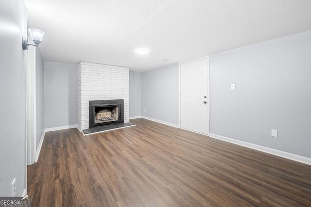 2352 S Hairston Rd, Decatur, GA 30035 - unfurnished living room with a brick fireplace, dark wood-style flooring, and baseboards
