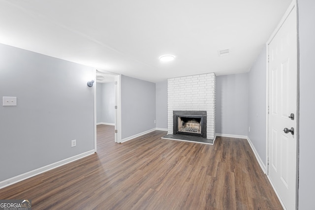 2352 S Hairston Rd, Decatur, GA 30035 - unfurnished living room with baseboards, a fireplace, wood finished floors, and visible vents