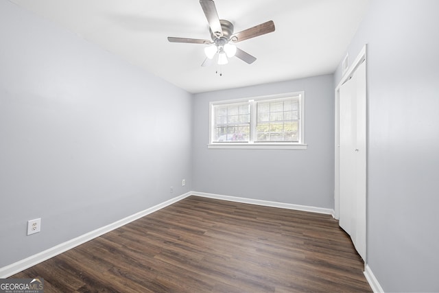 2352 S Hairston Rd, Decatur, GA 30035 - unfurnished bedroom with a ceiling fan, baseboards, dark wood-style floors, and a closet