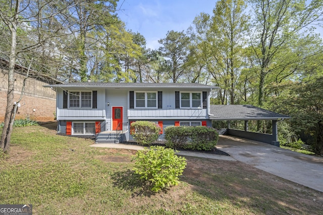 2352 S Hairston Rd, Decatur, GA 30035 - bi-level home featuring concrete driveway, board and batten siding, and a front yard