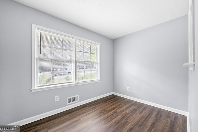 2352 S Hairston Rd, Decatur, GA 30035 - unfurnished room featuring plenty of natural light, baseboards, dark wood-style floors, and visible vents
