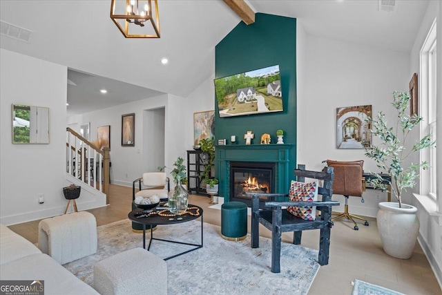 living room featuring stairway, visible vents, beam ceiling, a glass covered fireplace, and a notable chandelier