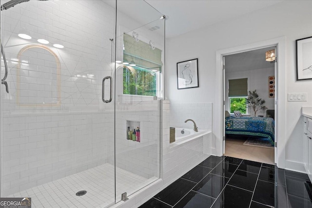 ensuite bathroom featuring a shower stall, a garden tub, tile patterned flooring, and ensuite bathroom