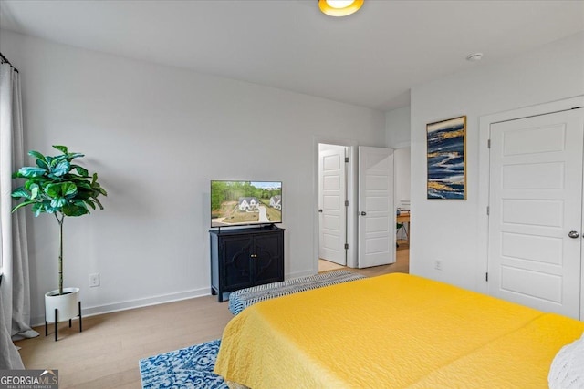 bedroom featuring light wood-style flooring and baseboards