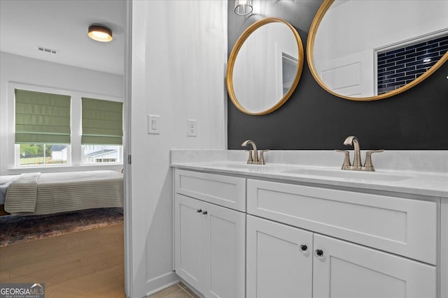 ensuite bathroom with visible vents, ensuite bath, a sink, and double vanity