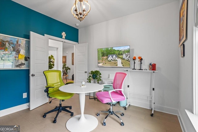 game room featuring baseboards and a notable chandelier