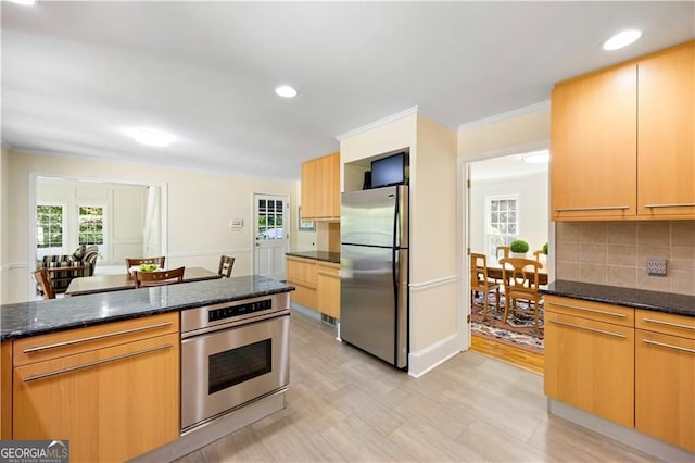 5655 Errol Pl NW, Atlanta, GA 30327 - kitchen with recessed lighting, stainless steel appliances, decorative backsplash, dark stone countertops, and crown molding