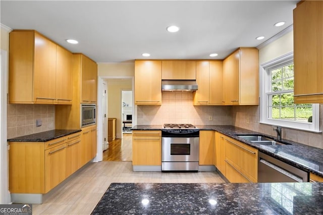 5655 Errol Pl NW, Atlanta, GA 30327 - kitchen featuring exhaust hood, dark stone counters, appliances with stainless steel finishes, a sink, and crown molding