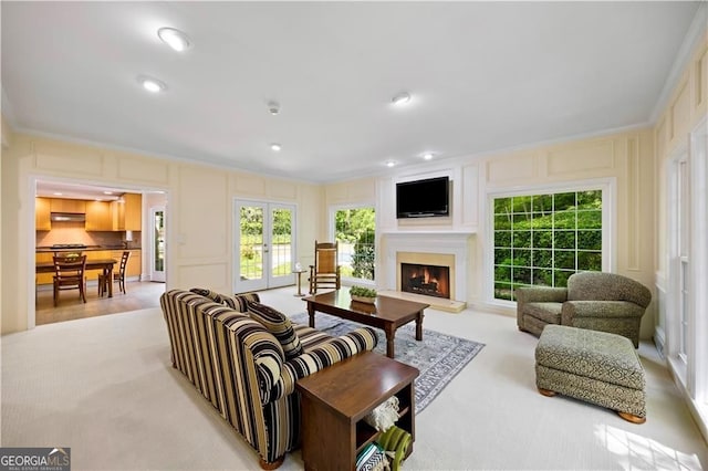 5655 Errol Pl NW, Atlanta, GA 30327 - living room with ornamental molding, a lit fireplace, french doors, and a decorative wall