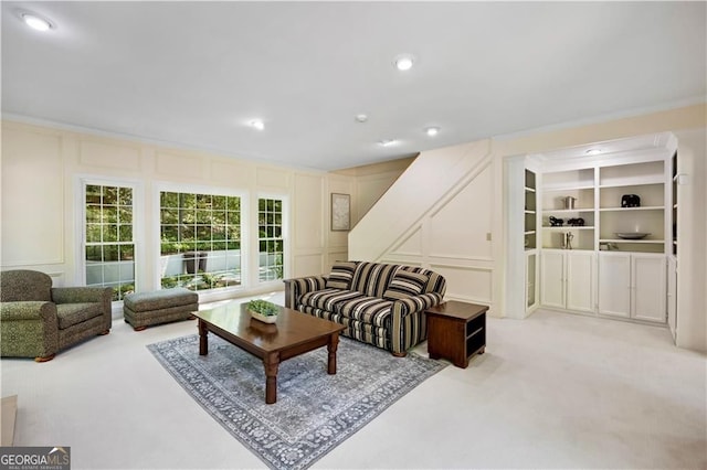 5655 Errol Pl NW, Atlanta, GA 30327 - living room with recessed lighting, crown molding, light colored carpet, and a decorative wall