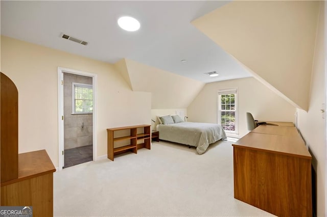 5655 Errol Pl NW, Atlanta, GA 30327 - bedroom featuring visible vents, light carpet, arched walkways, lofted ceiling, and ensuite bathroom