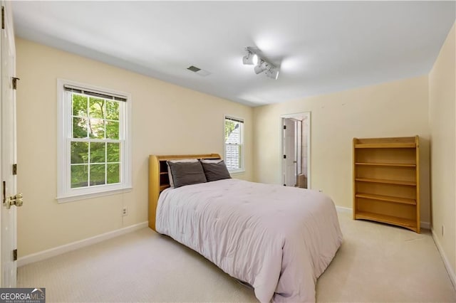5655 Errol Pl NW, Atlanta, GA 30327 - bedroom with track lighting, visible vents, light carpet, and baseboards