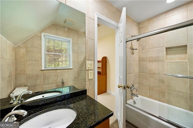 5655 Errol Pl NW, Atlanta, GA 30327 - full bathroom with lofted ceiling, combined bath / shower with glass door, vanity, and tile walls