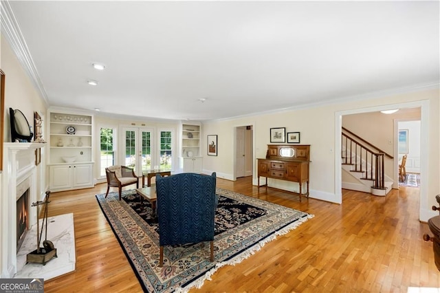 5655 Errol Pl NW, Atlanta, GA 30327 - living area with stairway, light wood-style flooring, ornamental molding, and built in features